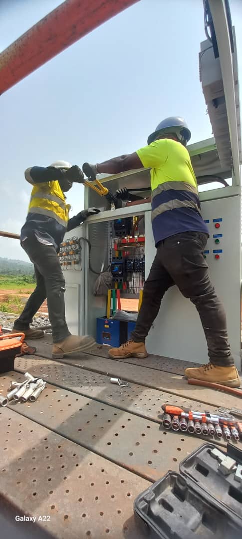 Two technicians torquing MV panel terminations on site